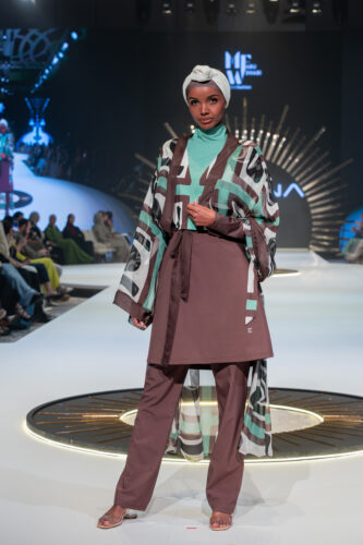 Halima Aden opens Marina Swimwear Runway at Abu Dhabi Modest Fashion Week, wearing brown and teal burkini.