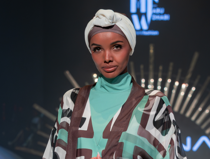 Halima Aden opens Marina Swimwear Runway at Abu Dhabi Modest Fashion Week, wearing brown and teal burkini.