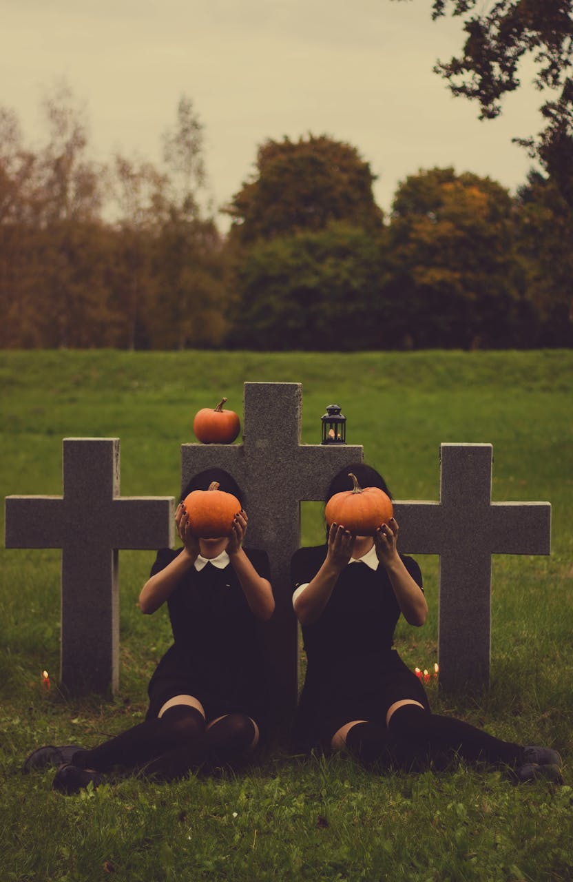 October 2025 HoroscopesEerie Halloween setting with pumpkins and cross gravestones at dusk, capturing an autumnal mood.