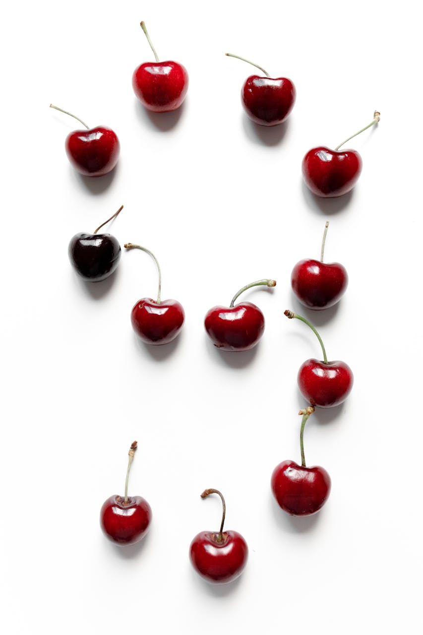 December 2025 Horoscope: Closing the Cycle 9 & Numerology ForecastFresh cherries artfully arranged to form the number nine on a white background.