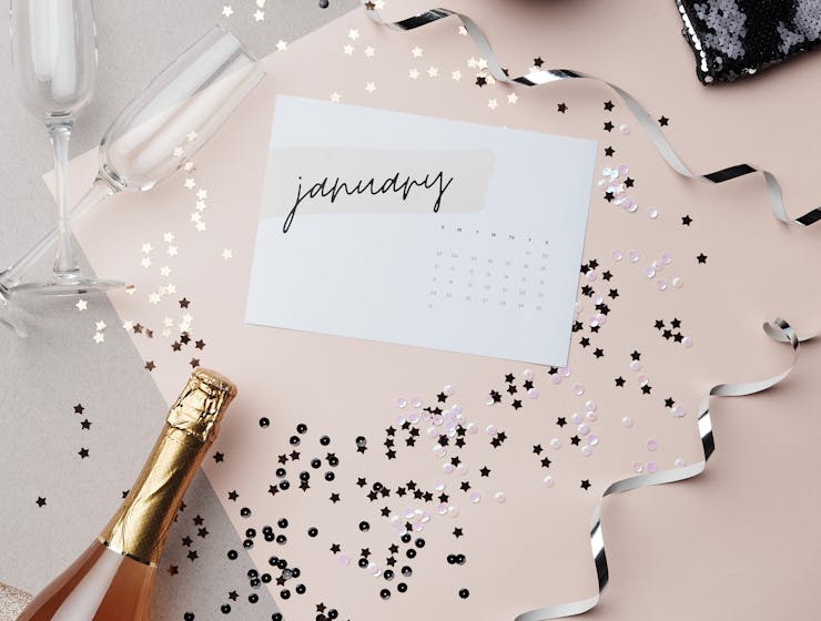 2026 Yearly HoroscopeChic New Year themed flat lay featuring champagne, glitter, disco ball, January calendar, and festive accessories.