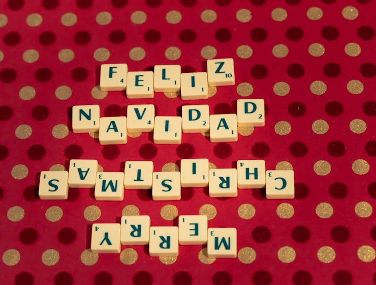 Top 5 Luxury Holiday Games to Play This SeasonScrabble tiles spelling 'Feliz Navidad Merry Christmas' on a festive polka dot backdrop.