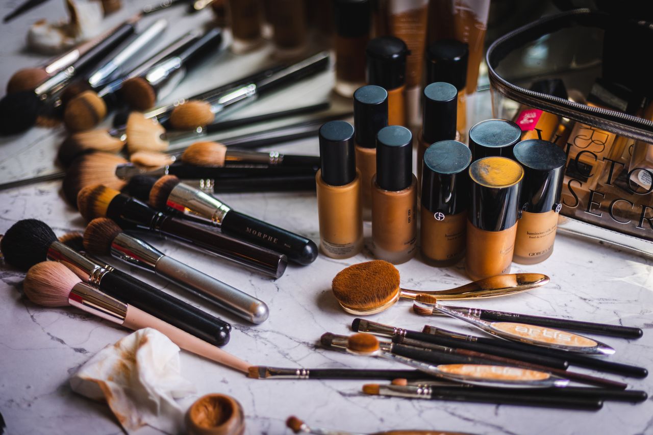 Understanding Makeup EssentialsA variety of makeup brushes and foundation bottles arranged on a marble surface, showcasing beauty essentials.