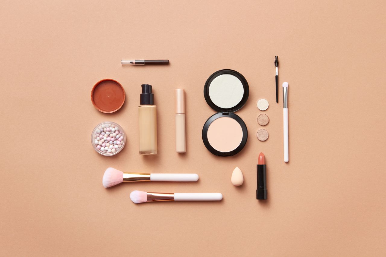 Understanding Makeup EssentialsStylish flatlay of various makeup products on a soft peach background.