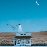 Focus Keyphrase: August 2026 Horoscopes Claudia VanniniA minimalistic Chanel store illuminated by street lamps under a crescent moon and starry night sky.