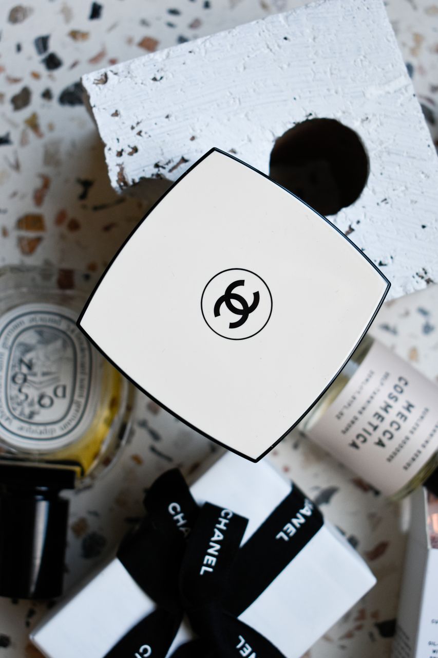 End-of-Summer Luxury Travel Beauty Essentials & Golden Hour Glow GuideModern flat lay showcasing luxury perfumes and gift boxes, perfect for lifestyle and fashion themes.